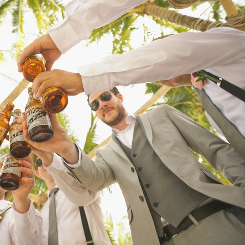 Friends clinking beer bottles, seen from below