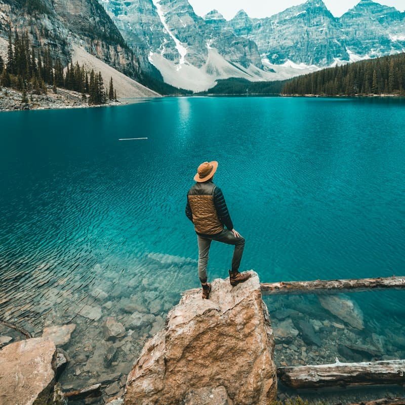 A hiker on a rock above Moraine Lake