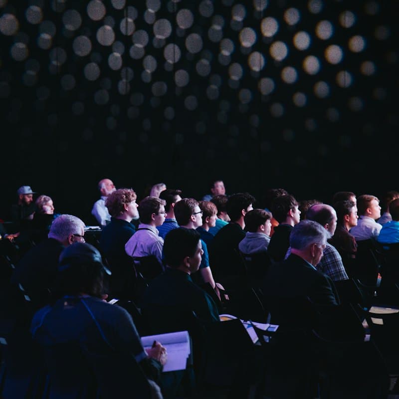 A full conference room seen from the back