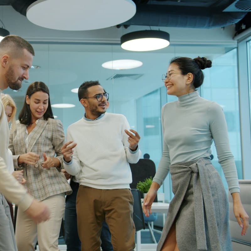 Colleagues dancing and celebrating in an office