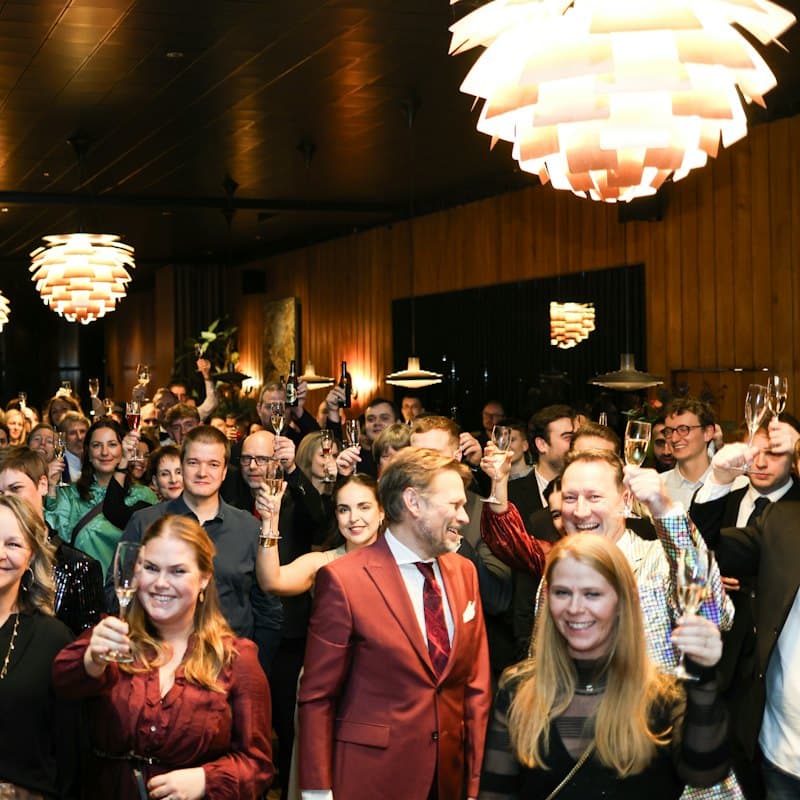 A large group waving at the camera